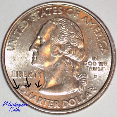2000 New Hampshire quarter showing the Spitting Old Man die crack — raised metal line running from the mouth of the Old Man of the Mountain rock profile