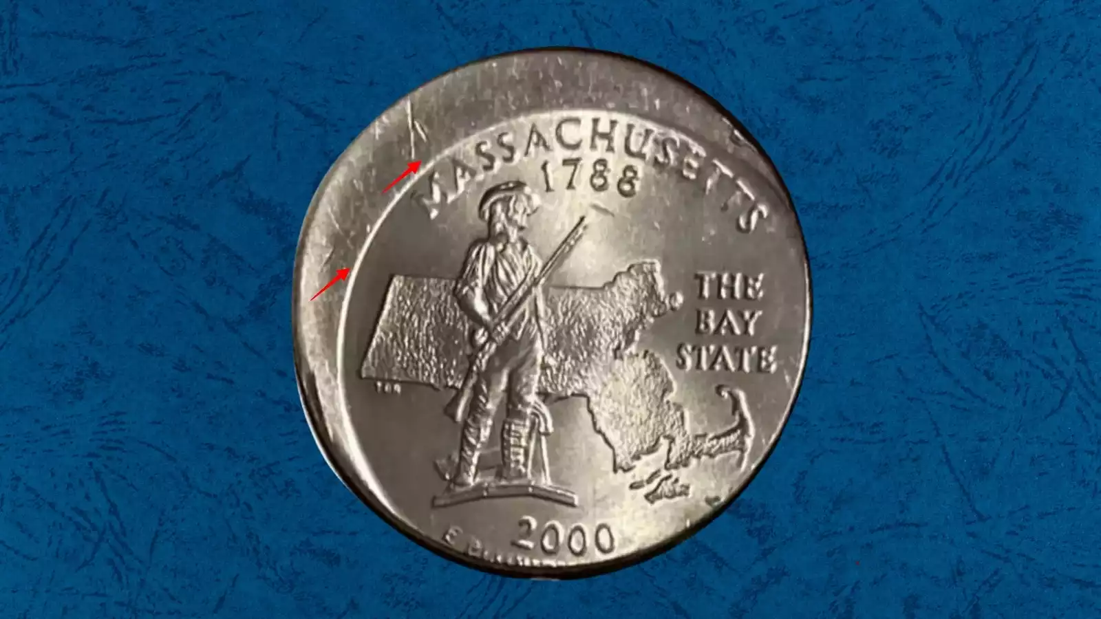 2000 New Hampshire quarter off-center strike error showing blank crescent arc on one edge with design shifted to the opposite side
